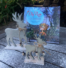 Load image into Gallery viewer, Elly Rose in Denmark book written and illustrated by Maggie O'Hara on a table with Christmas deer and fake snow