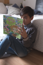 Load image into Gallery viewer, Young boy in his bedroom reading Elly Rose in Sri Lanka written and illustrated by Maggie O'Hara