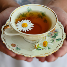 Load image into Gallery viewer, A cup of Fleur Tea hormone balancing tea in a pretty tea cup
